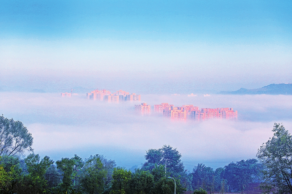 　　10月18日，天空放睛，城区出现平流雾景观。进入深秋季节，昼夜温差较大，城市建筑被平流雾缠绕若隐若现，如梦似幻。 记者黄舒摄
